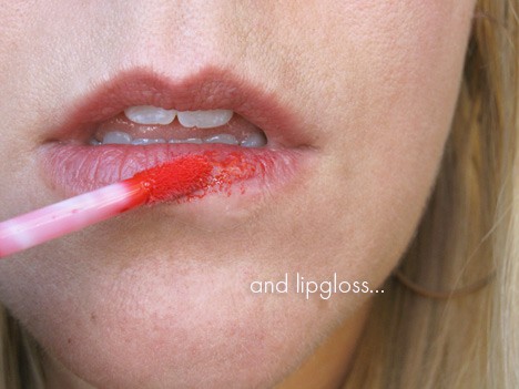 Een close-up afbeelding van de lippen van de vrouw die lipgloss aanbrengen