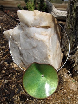 Groene ketting aan een draadketting op een rots